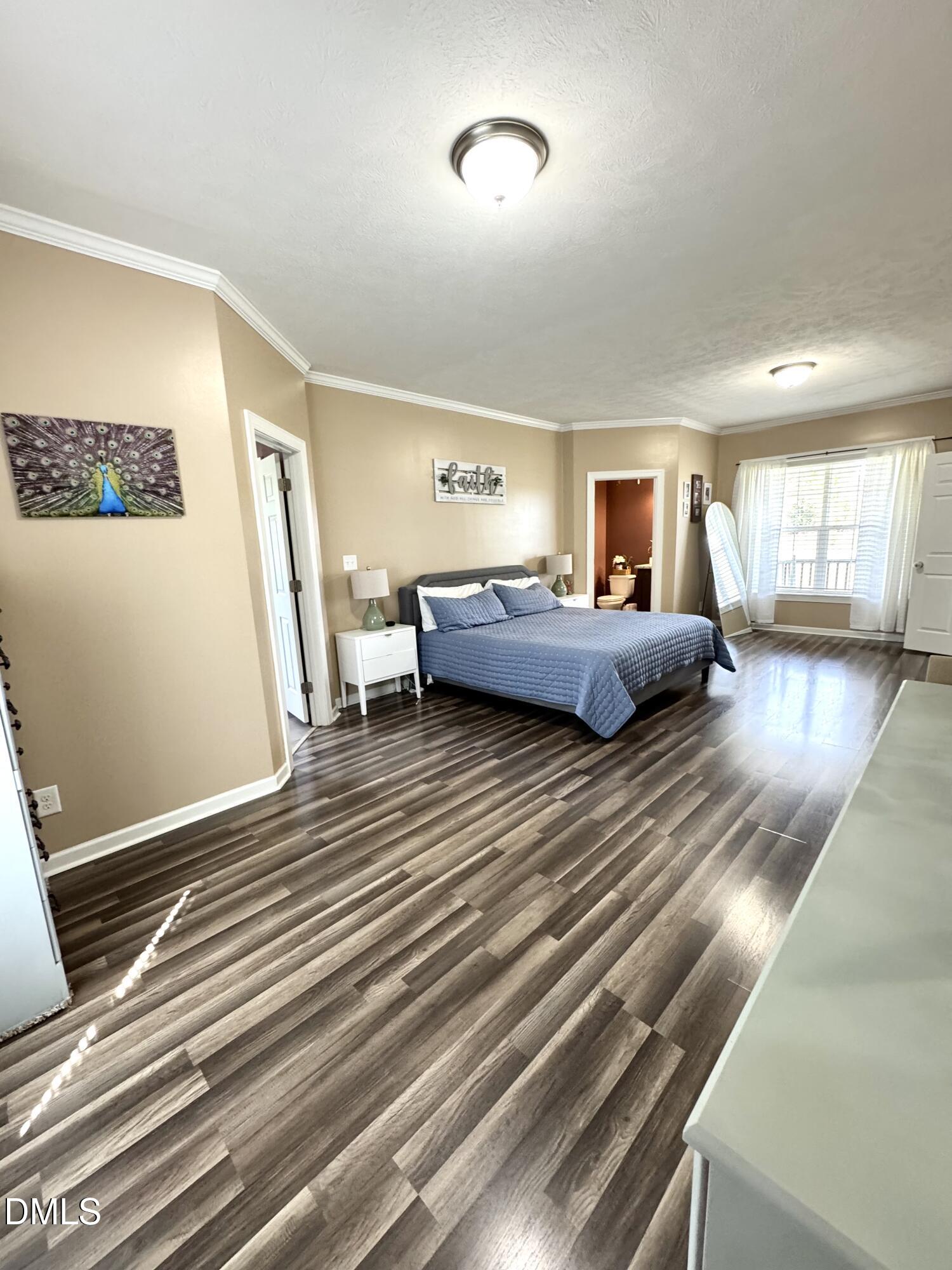 640 Tart Town Road Dunn, NC 28334 - Photo 31 of 71 a bedroom with a bed and wooden floor