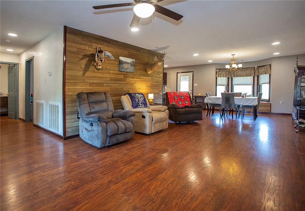 3726 St Joe Road Atkins, AR 72823 - Photo 9 of 41 Open concept living area featuring wood-finish flooring, recessed lighting, and a decorative wood plank accent wall