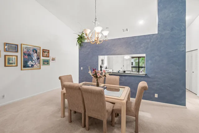 a dining room with furniture and chandelier