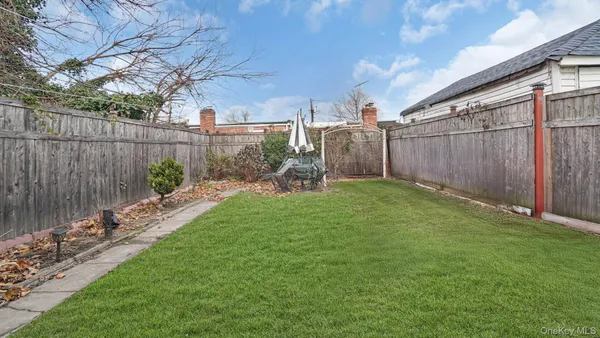 a view of a backyard with wooden fence