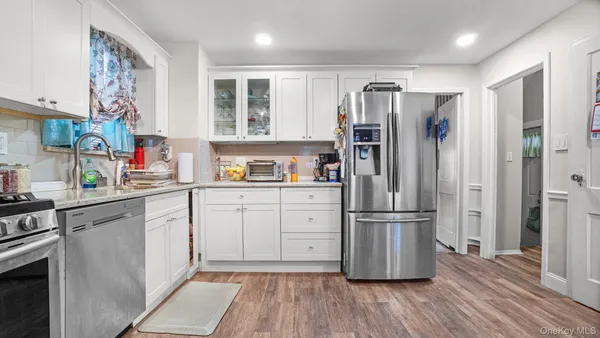 a kitchen with stainless steel appliances a refrigerator sink and cabinets
