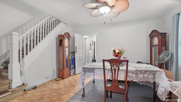 a dining room with furniture and wooden floor
