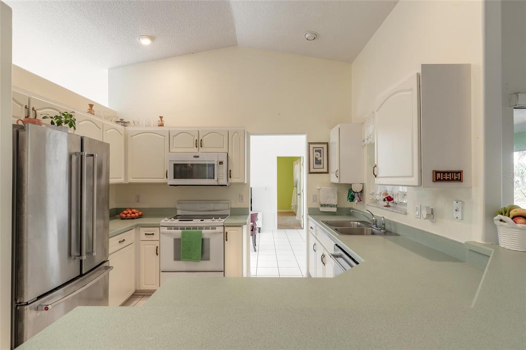 39 Princess Ruth Lane Palm Coast, FL 32164 - Photo 13 of 48 a kitchen with stainless steel appliances a stove a sink and a refrigerator