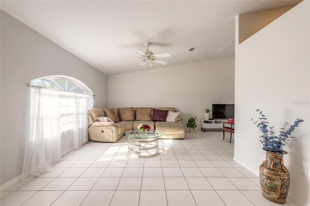 39 Princess Ruth Lane Palm Coast, FL 32164 - Photo 17 of 48 a living room with furniture and a chandelier