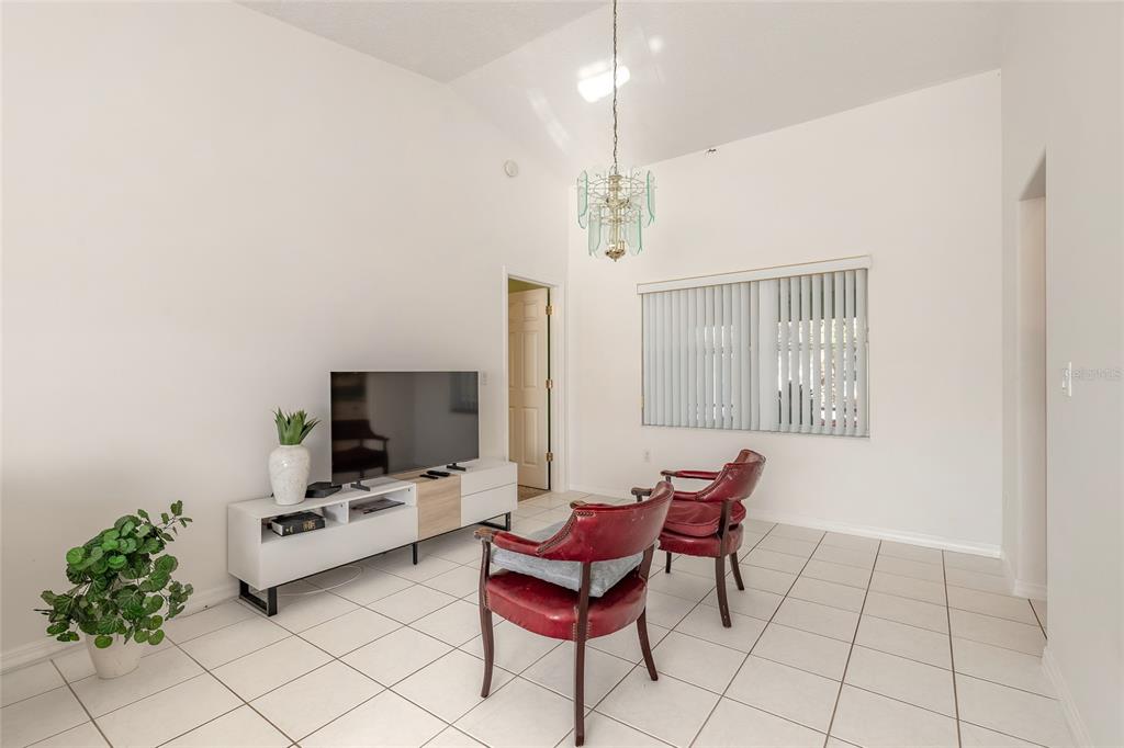 39 Princess Ruth Lane Palm Coast, FL 32164 - Photo 21 of 48 a living room with furniture and a flat screen tv
