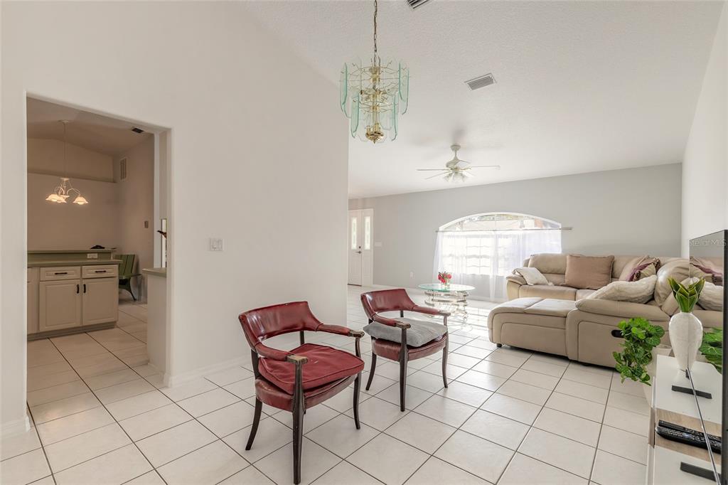 39 Princess Ruth Lane Palm Coast, FL 32164 - Photo 22 of 48 a living room with furniture and a chandelier