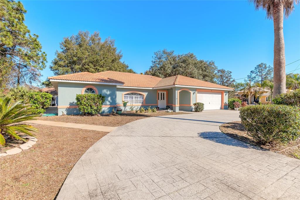 39 Princess Ruth Lane Palm Coast, FL 32164 - Photo 3 of 48 a front view of a house with a yard