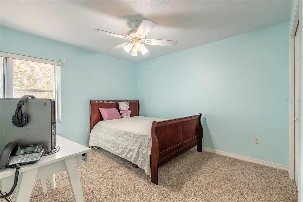 39 Princess Ruth Lane Palm Coast, FL 32164 - Photo 32 of 48 a room with a bed and a chandelier