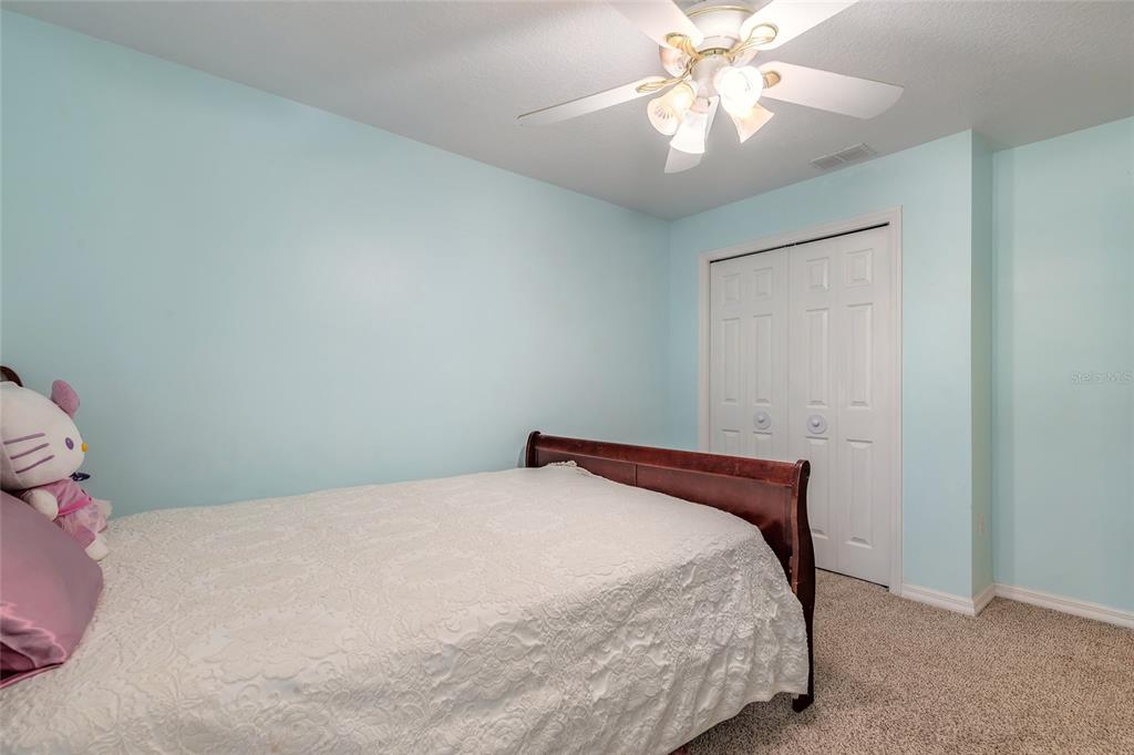 39 Princess Ruth Lane Palm Coast, FL 32164 - Photo 33 of 48 a bedroom with a bed and a chandelier fan
