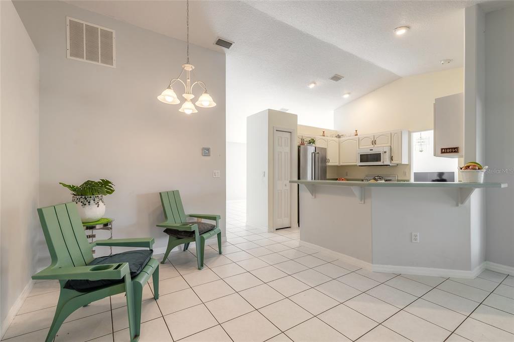 39 Princess Ruth Lane Palm Coast, FL 32164 - Photo 7 of 48 a kitchen with cabinets and chairs