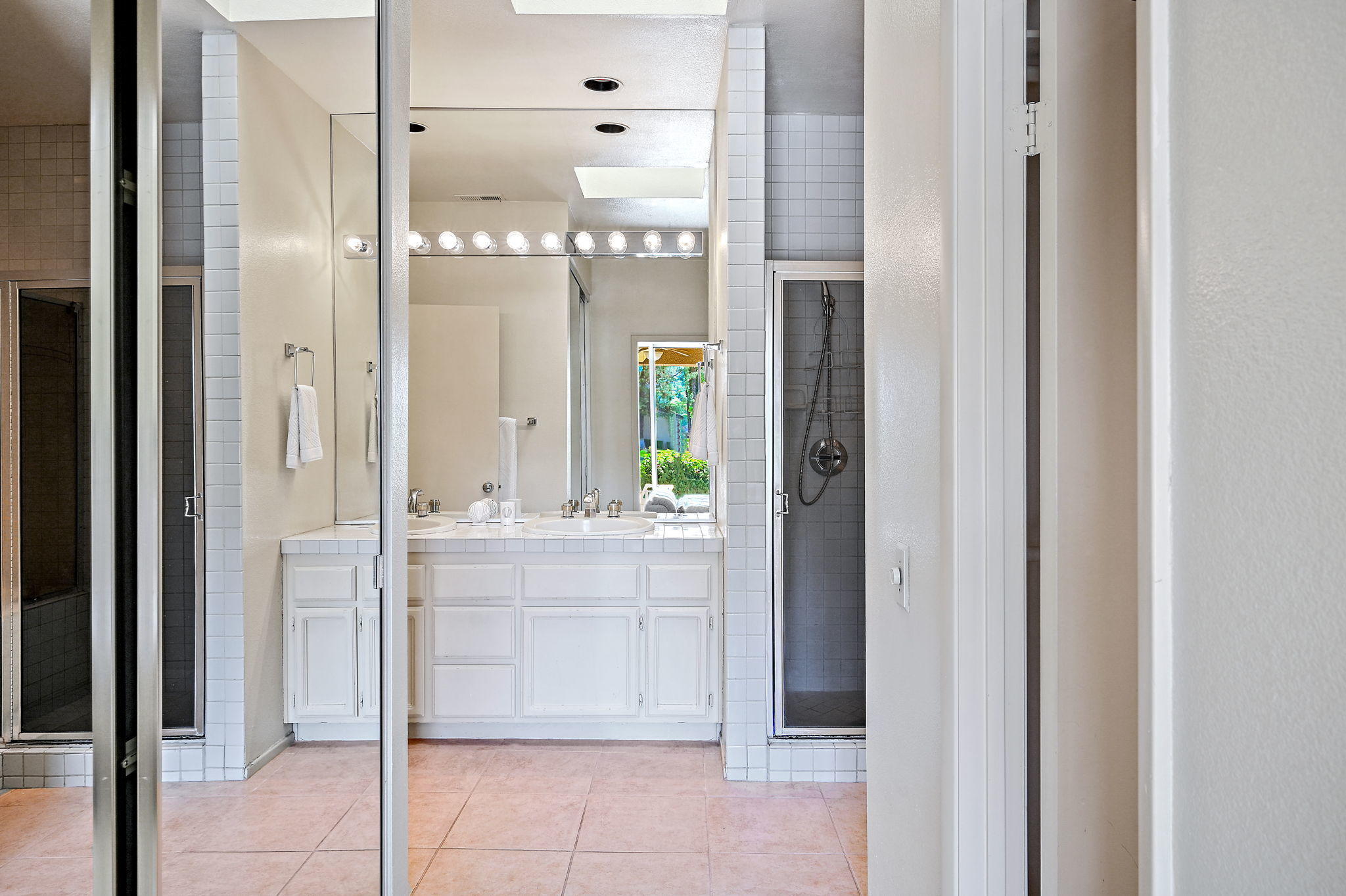 151 Lakeshore Drive Rancho Mirage, CA 92270 - Photo 14 of 37 a bathroom with a glass shower door and a mirror