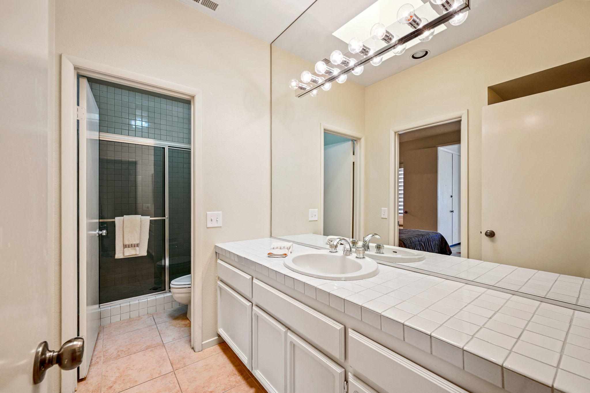 151 Lakeshore Drive Rancho Mirage, CA 92270 - Photo 24 of 37 a spacious bathroom with a double vanity sink a mirror and shower