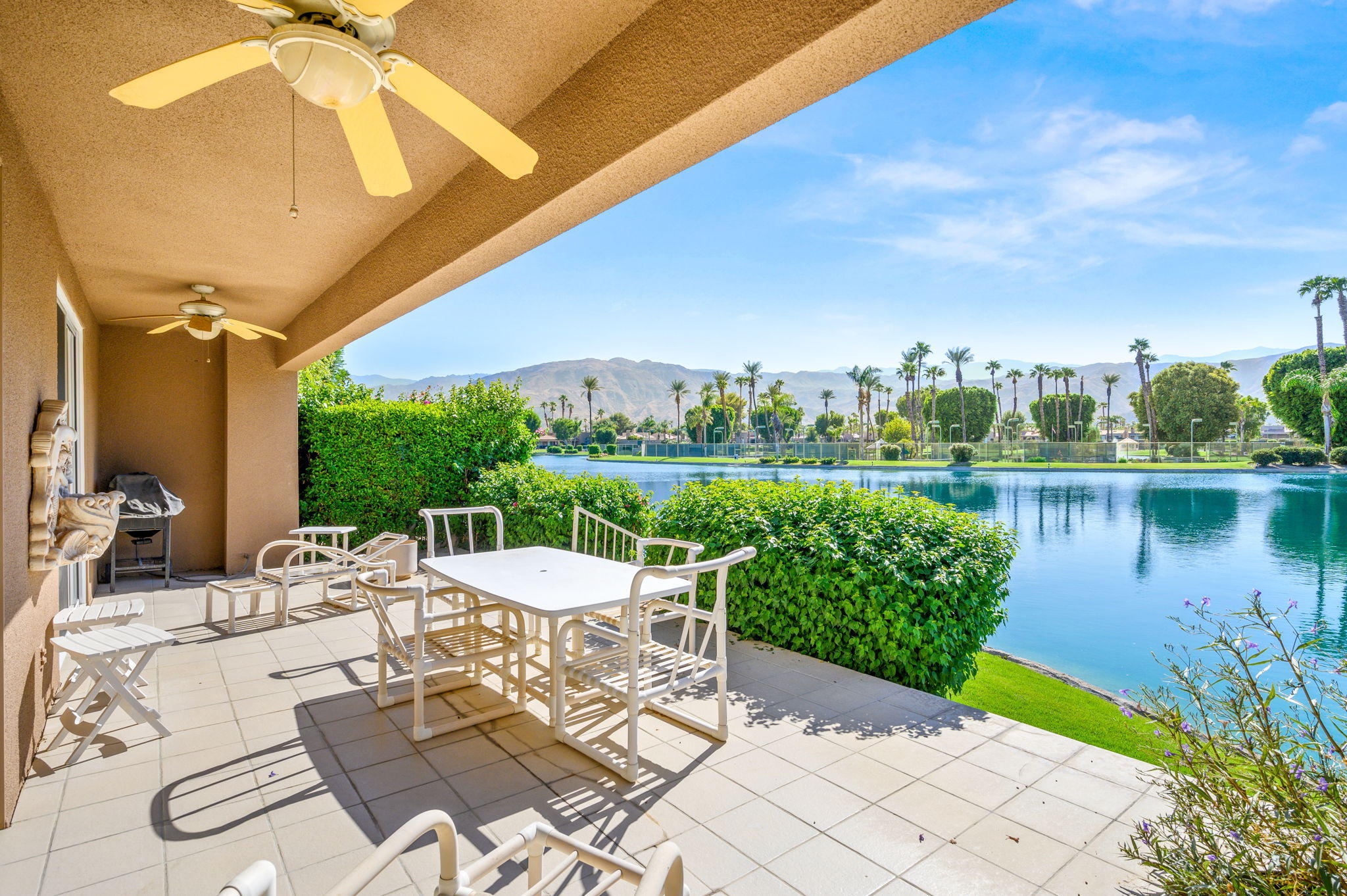 151 Lakeshore Drive Rancho Mirage, CA 92270 - Photo 28 of 37 a view of a patio with a table chairs and a swimming pool