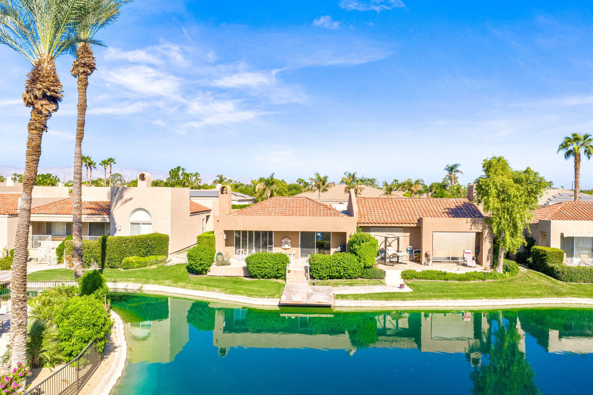 151 Lakeshore Drive Rancho Mirage, CA 92270 - Photo 29 of 37 a front view of a house with a garden and plants