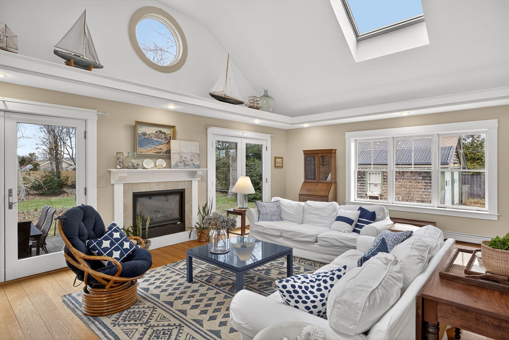 89 Rock Harbor Road Orleans, MA 02653 - Photo 11 of 39 a living room with furniture a fireplace and window