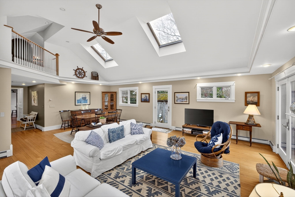 89 Rock Harbor Road Orleans, MA 02653 - Photo 13 of 39 a living room with furniture a rug and a flat screen tv