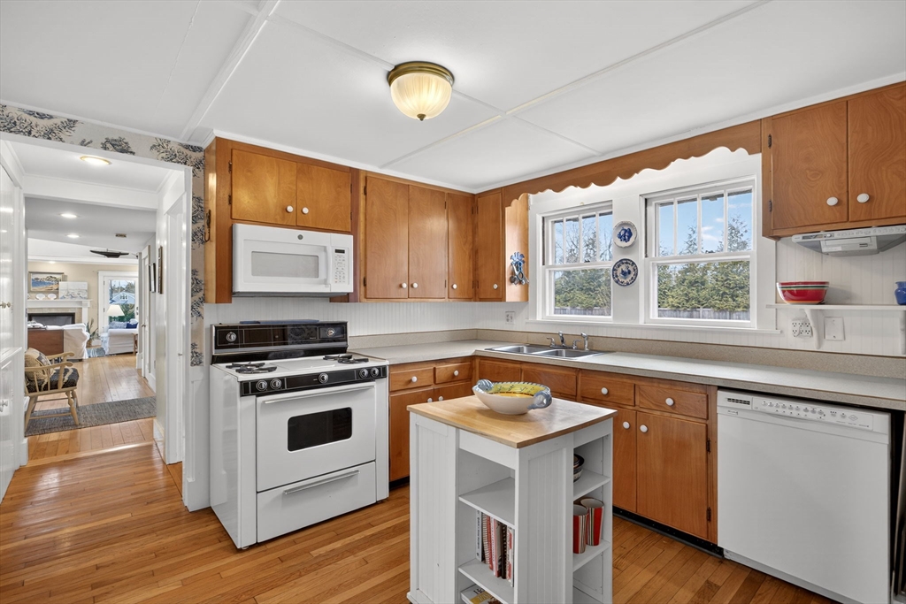 89 Rock Harbor Road Orleans, MA 02653 - Photo 18 of 39 a kitchen with a stove a sink and a microwave