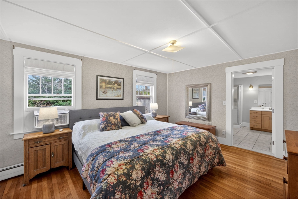 89 Rock Harbor Road Orleans, MA 02653 - Photo 19 of 39 a bedroom with a large bed and a wooden floor