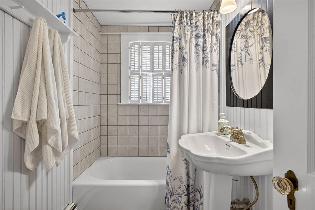 89 Rock Harbor Road Orleans, MA 02653 - Photo 26 of 39 a bathroom with a sink and a mirror