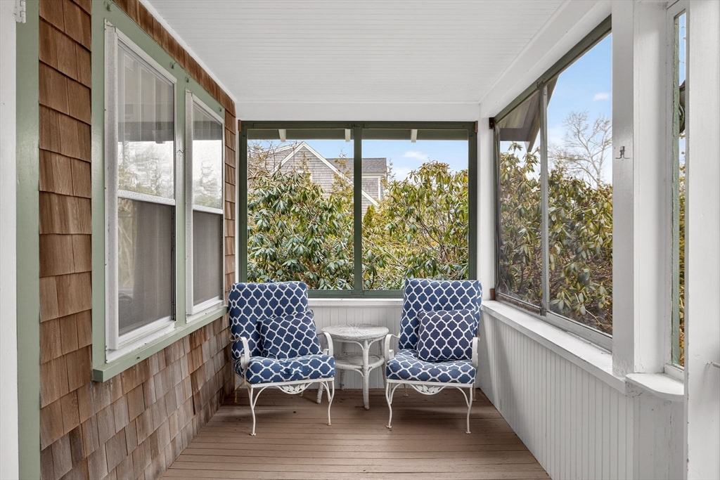 89 Rock Harbor Road Orleans, MA 02653 - Photo 27 of 39 a view of two chairs in the balcony with wooden floor