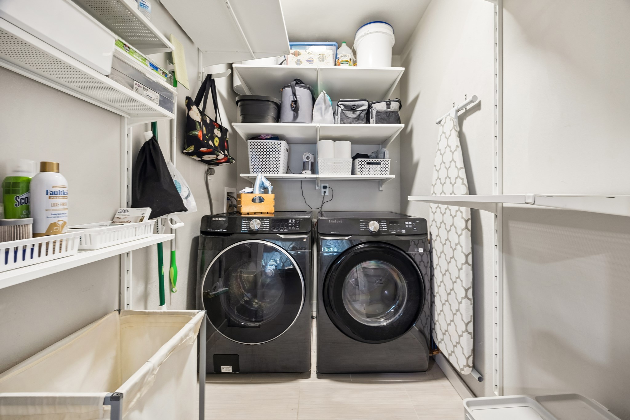 4514 Warm Springs Road Houston, TX 77035 - Photo 20 of 31 This photo shows a well-organized laundry room which has ample shelving for storage, folding & hanging space that is functional and efficient.