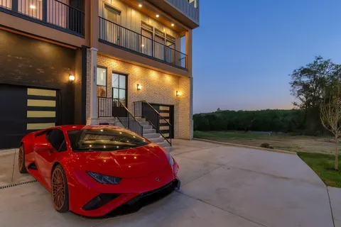 a living room with furniture a rug and kitchen view