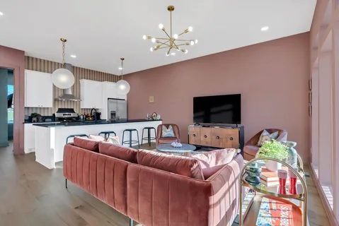 a living room with furniture and a floor to ceiling window