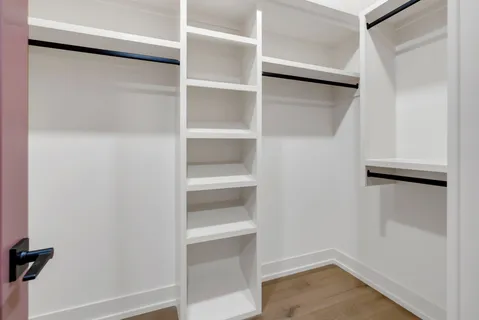 a bedroom with a large bed and a large window