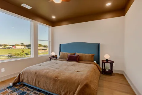 a bathroom with a granite countertop sink a toilet and a mirror