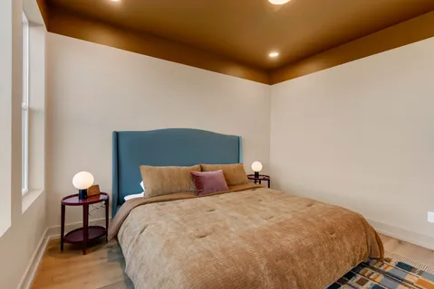 a bathroom with a granite countertop toilet a sink a mirror and shower