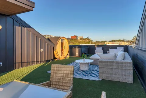 a living room with a couch and a potted plant