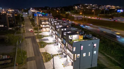 a view of a brick building next to a yard