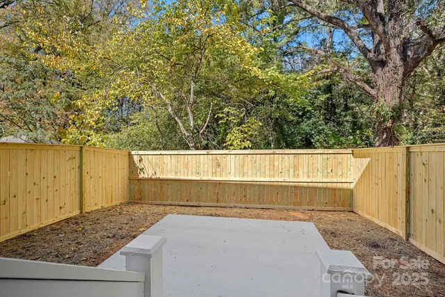 a view of wooden fence and trees