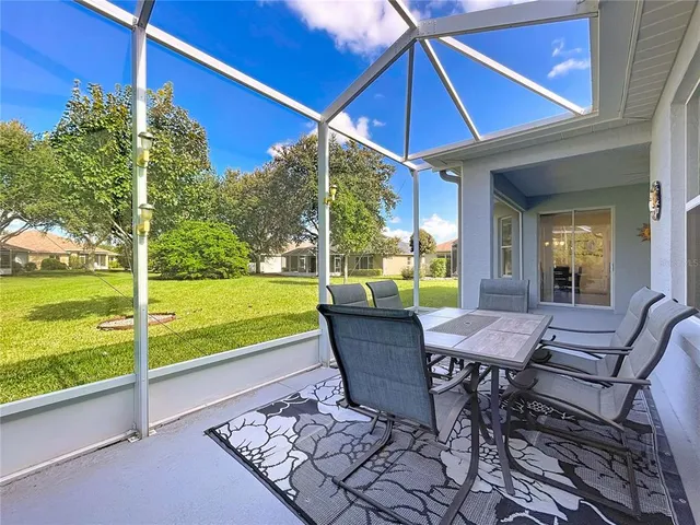 an aerial view of a house yard swimming pool and outdoor seating