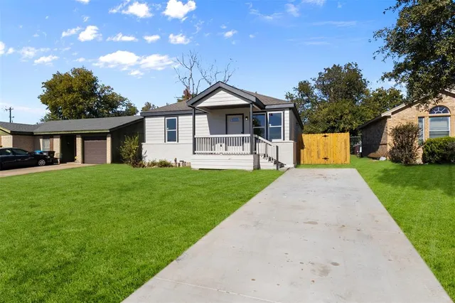 a front view of a house with yard and green space