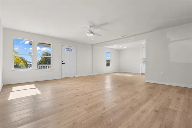 wooden floor in an empty room with a window