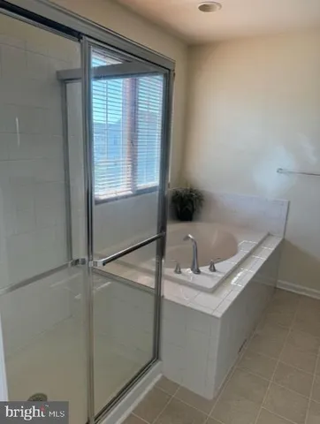 a bathroom with a tub and a sink