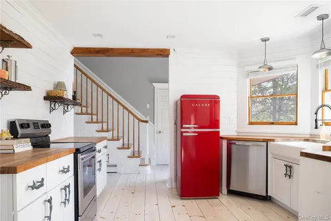a kitchen with stainless steel appliances granite countertop a stove and a sink with cabinets