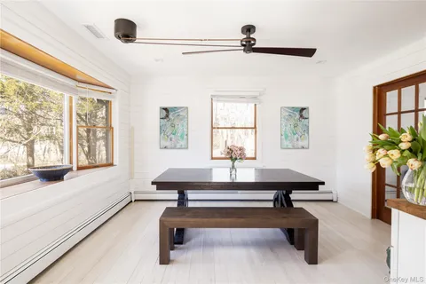 a living room with furniture pool table and a window