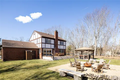 a view of a house with swimming pool and sitting area