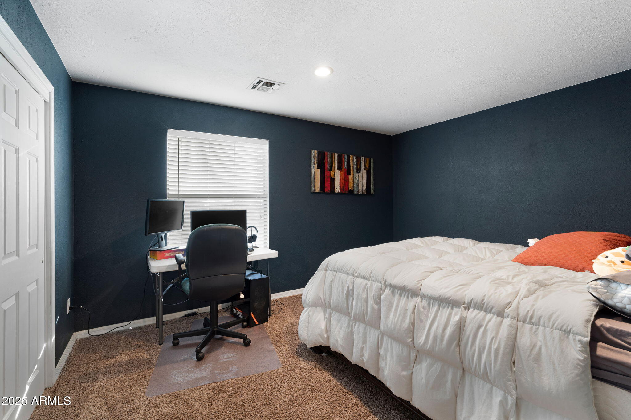 117 North Arroya Road Apache Junction, AZ 85119 - Photo 14 of 27 a bedroom with a bed a desk and chair