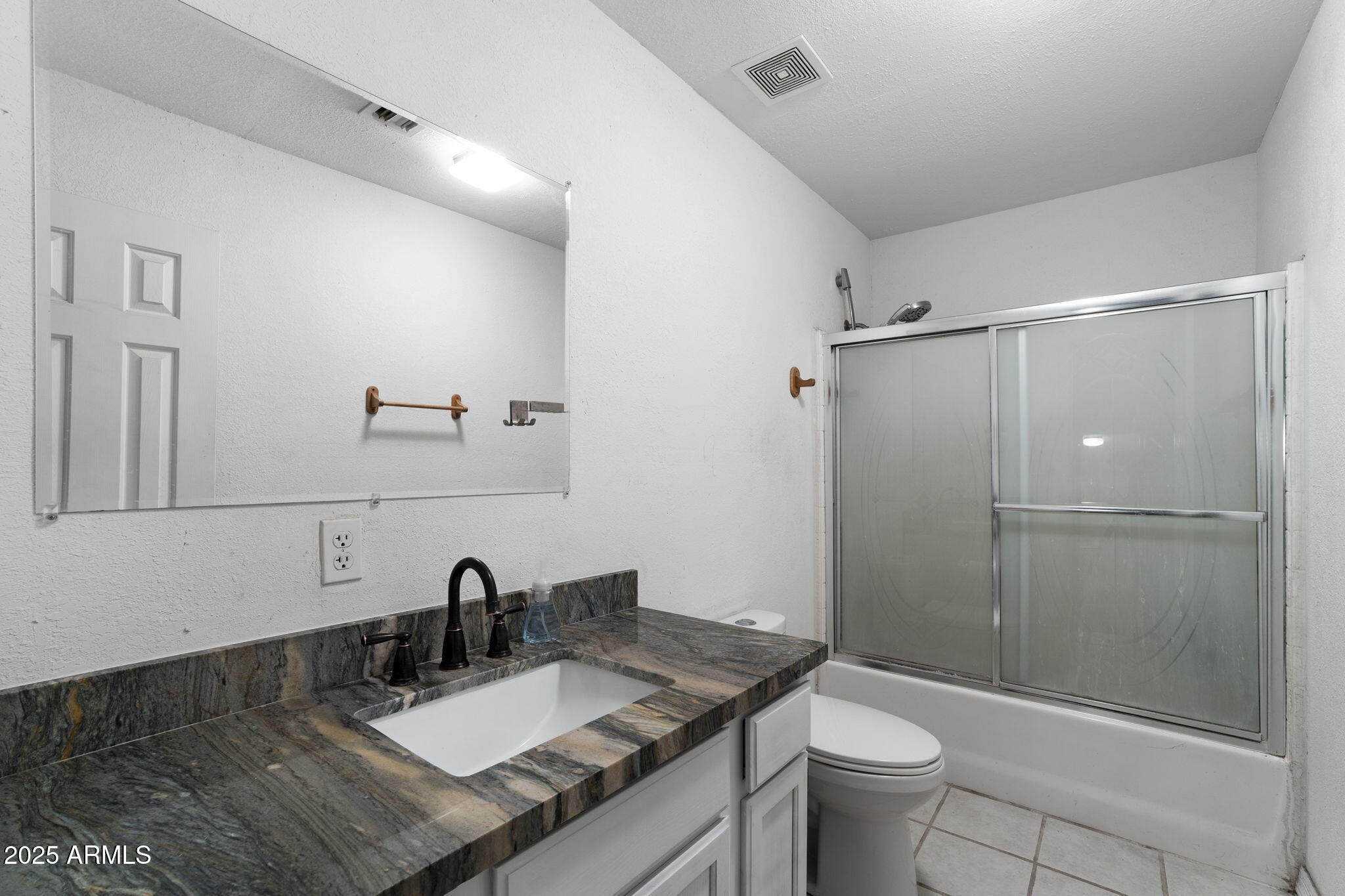 117 North Arroya Road Apache Junction, AZ 85119 - Photo 16 of 27 a bathroom with a granite countertop sink toilet and shower