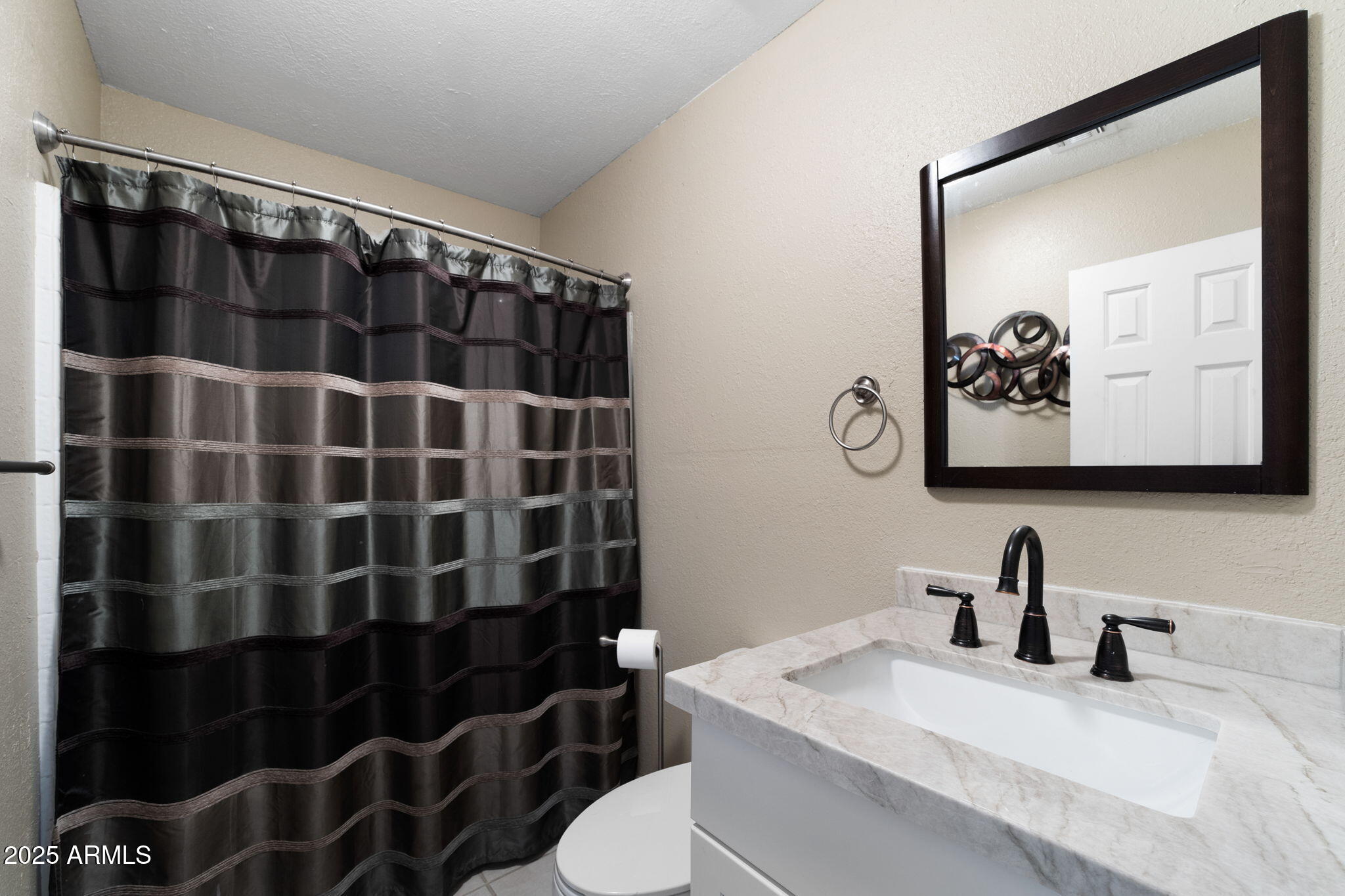 117 North Arroya Road Apache Junction, AZ 85119 - Photo 17 of 27 a bathroom with a sink toilet and shower
