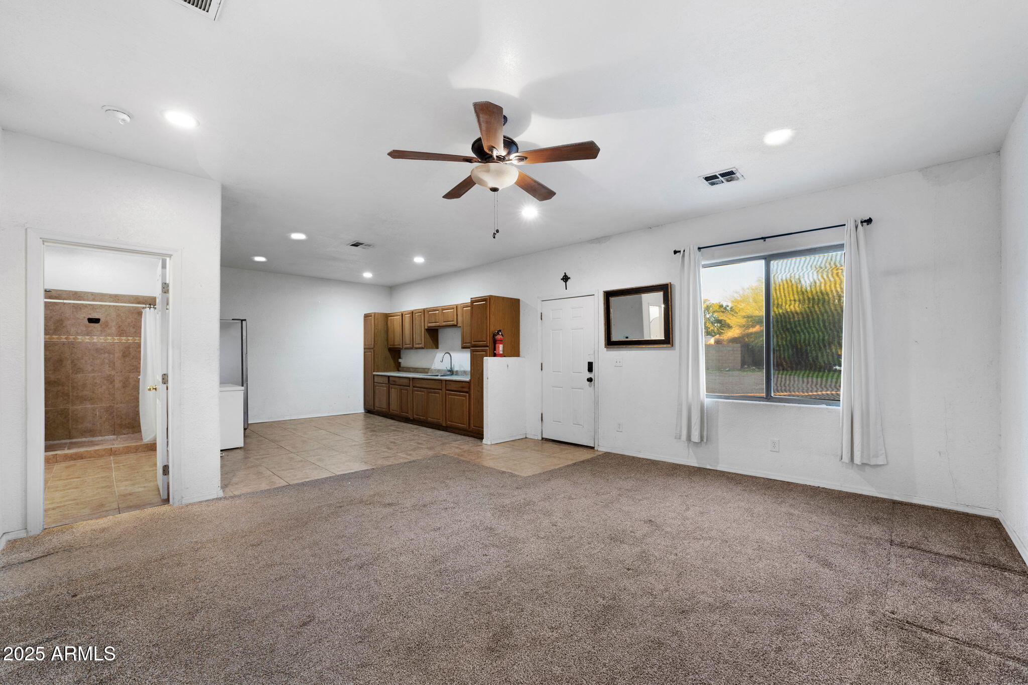 117 North Arroya Road Apache Junction, AZ 85119 - Photo 20 of 27 an empty room with windows and ceiling fan