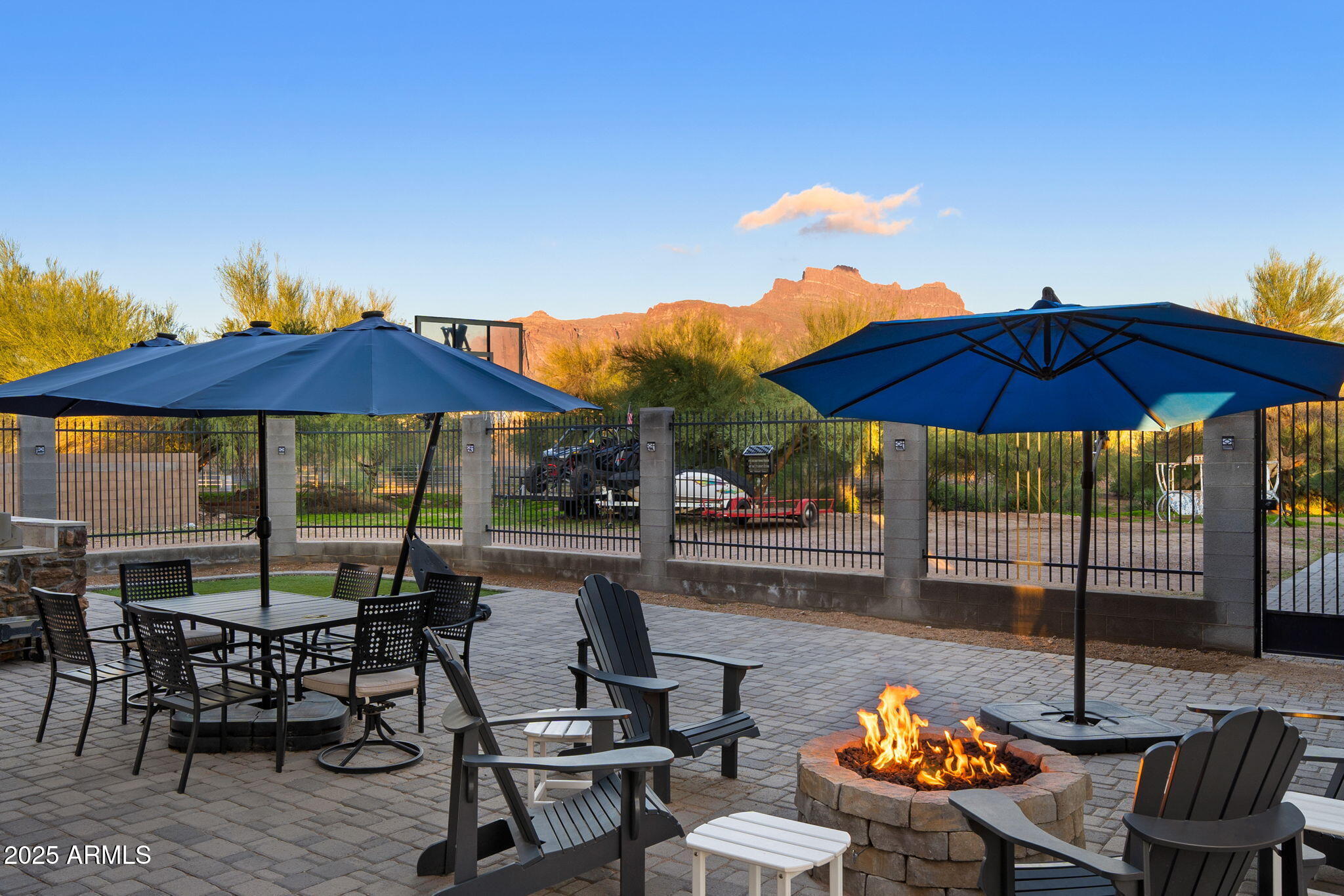 117 North Arroya Road Apache Junction, AZ 85119 - Photo 27 of 27 a view of a patio with chairs and table under an umbrella with the umbrella