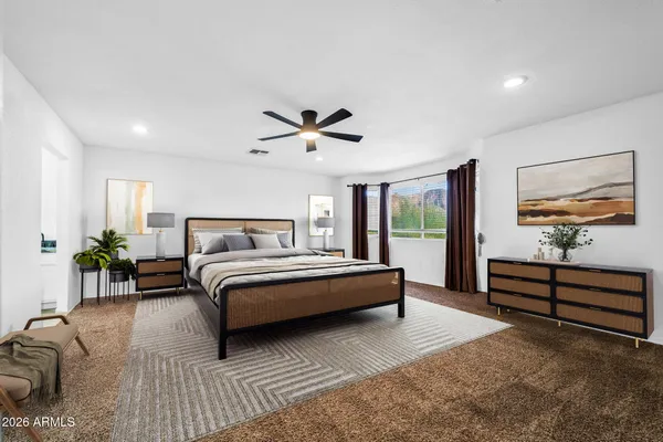 a spacious bedroom with a bed and a chandelier