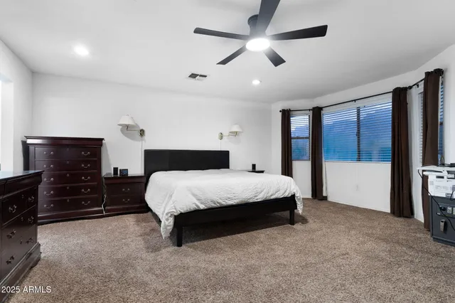 a bedroom with a large bed and a tv