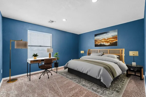 a bedroom with a bed a desk and chair