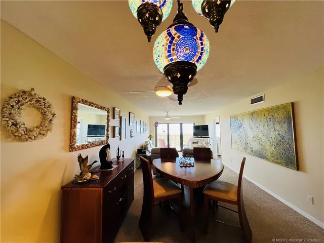 a living room with furniture a flat screen tv and a window