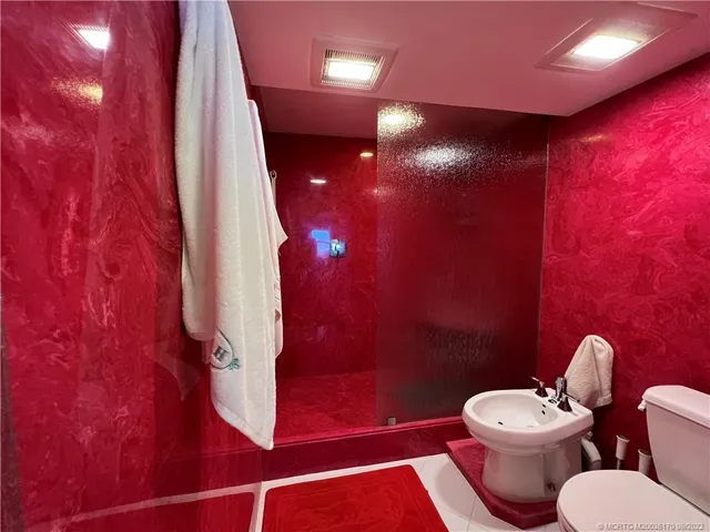 a bathroom with a sink toilet and a mirror